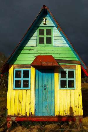 A Colorful Rustic House and Dark Storm Clouds Journal de Press, Benton