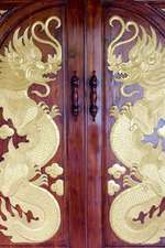 Two Gold Dragons on a Door in Thailand Journal